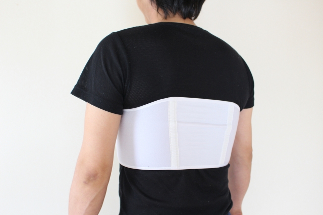 あばら骨が痛くて固定する男性