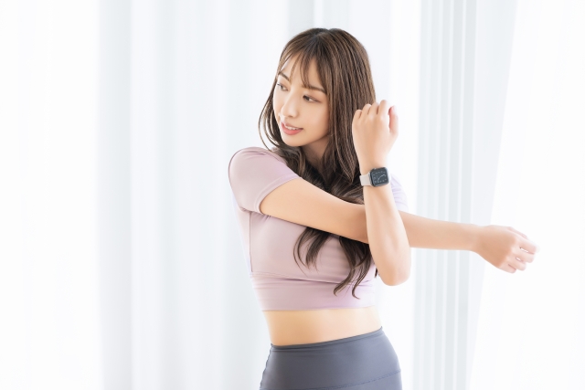 肩こりやストレートネックの悩みにストレッチをする女性